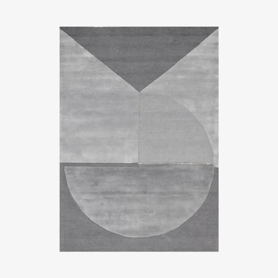 Abstract geometric rug with triangles, circles, and squares in gray.