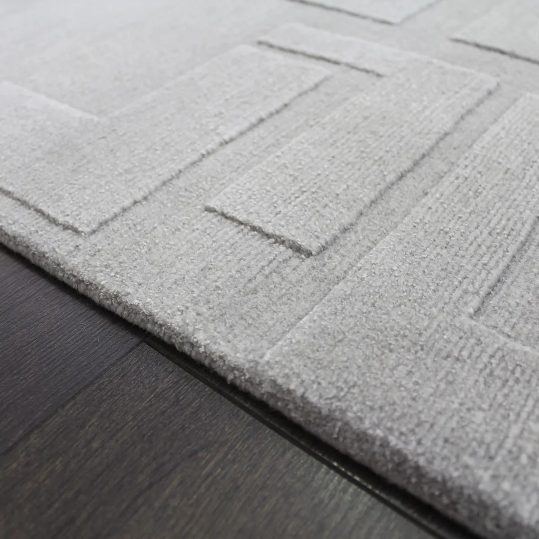 Modern gray rug with textured maze design.