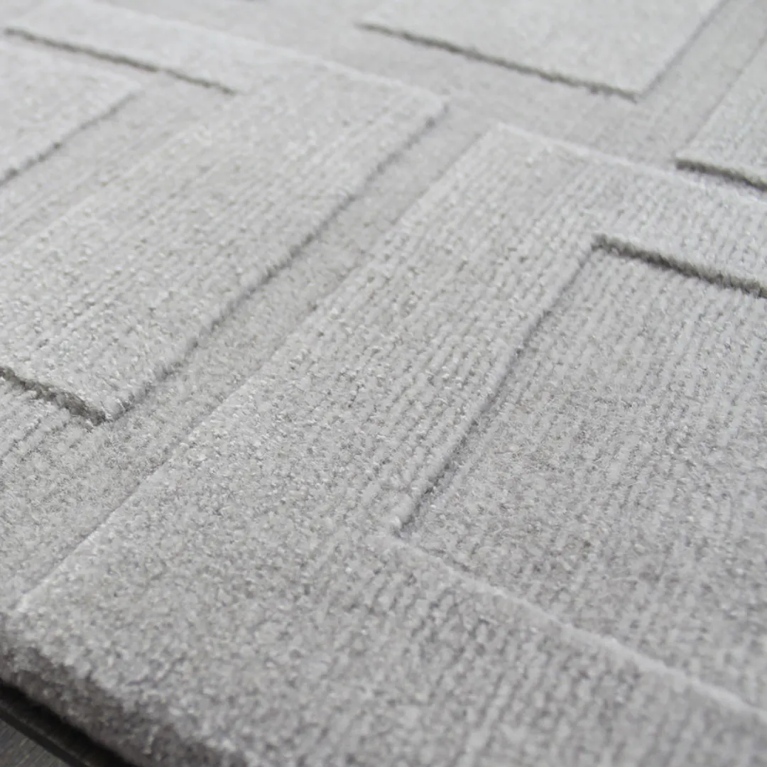 Sleek gray area rug with intricate geometric design.