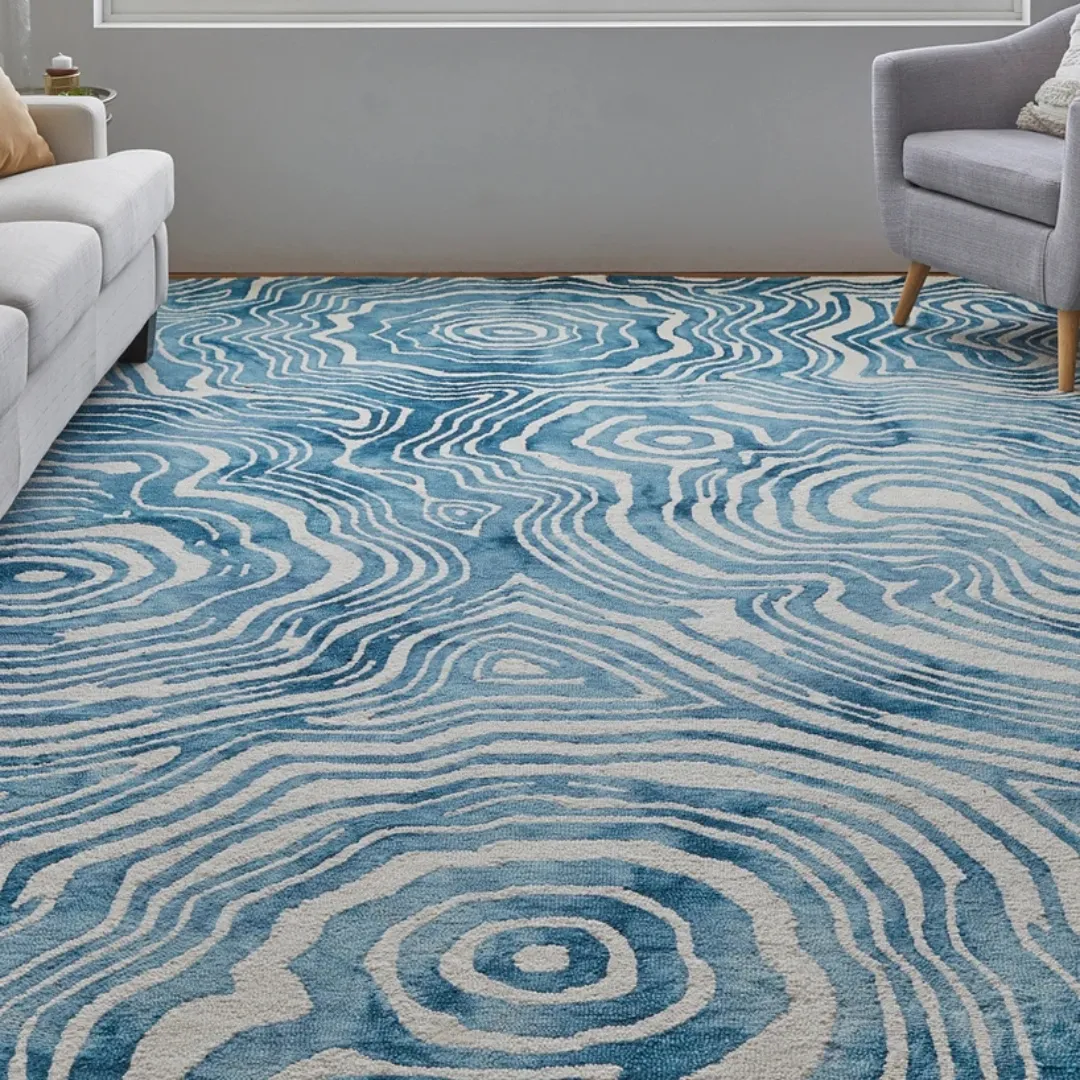 Vibrant blue area rug featuring flowing waves and concentric lines.