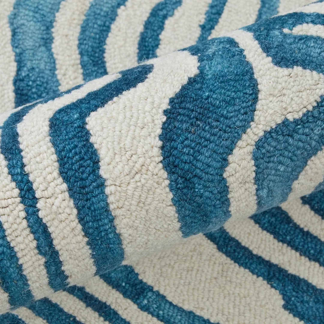 Modern abstract rug with blue wavy design and organic shapes.