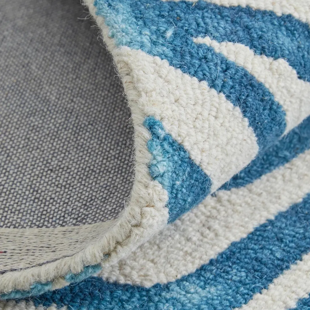 Abstract blue rug with flowing wave patterns for a calming effect.