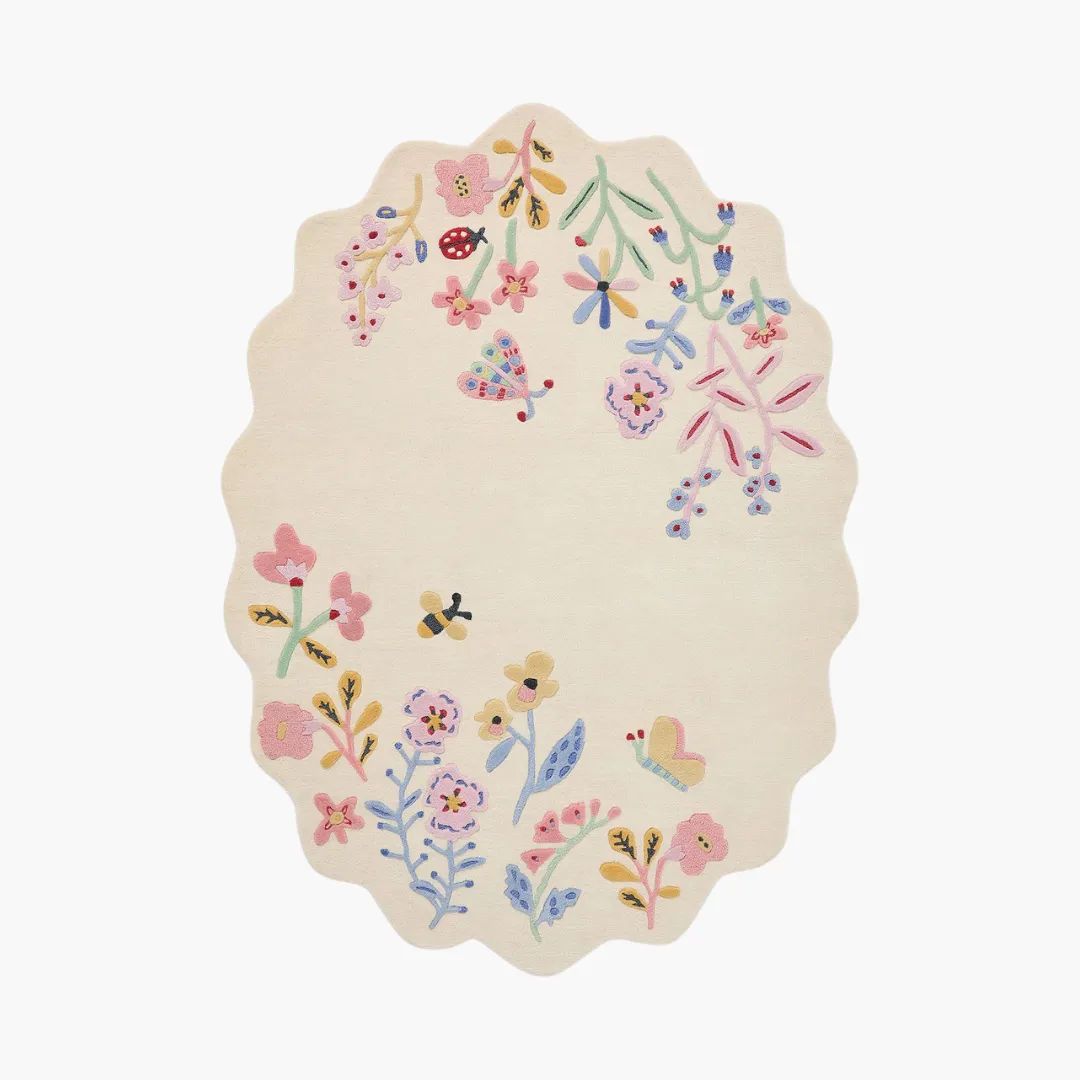 Honey Lull Meadow Rug Honey Lull Meadow Rug featuring pastel floral embroidery and playful bees – hand-tufted oval rug by Sneagear