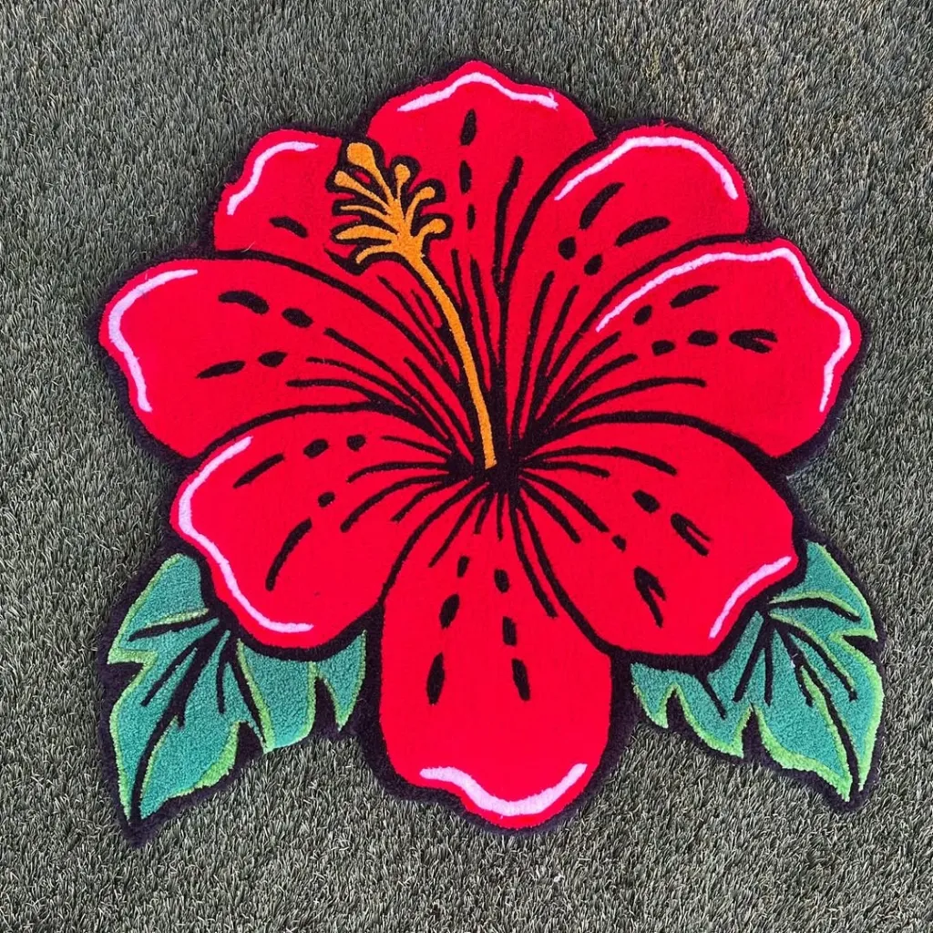 Ember Petal Hibiscus Flower Shaped Inked Rug Top View Top down view of the custom shaped Ember Petal rug featuring a vibrant red hibiscus flower design with green leaves on a dark background.