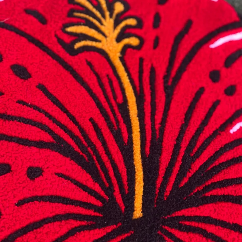 Ember Petal Rug Red Flower Stamen Texture Close up texture detail of the Ember Petal rug showing the black outlining and yellow stamen on the red wool petals.