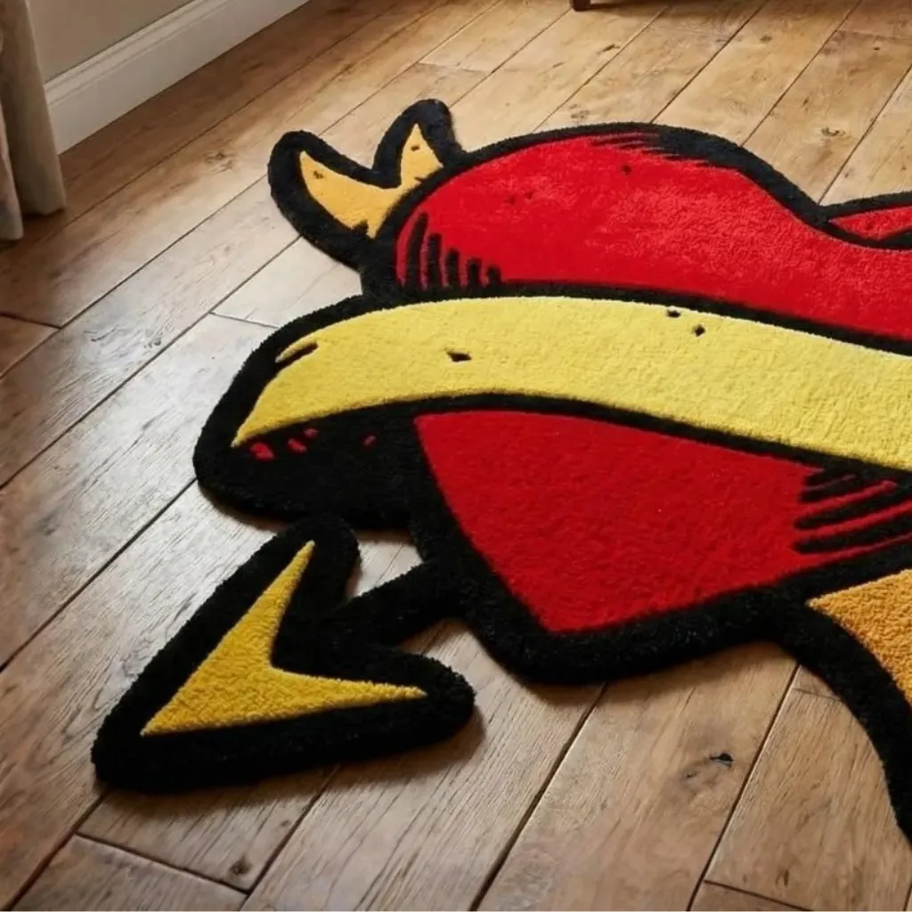 Wounded Heart Rug Red and Yellow Tufted Texture Close up angled perspective of the Wounded Heart rug showing the vibrant red wool and black outline of the tattoo inspired design.