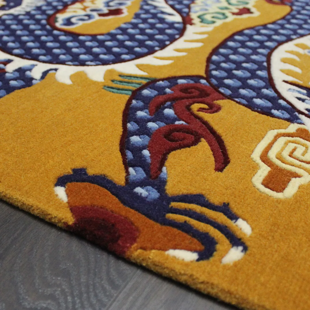 Imperial Golden Rug A luxury hand tufted wool area rug in golden ochre, displaying a bold oriental dragon pattern with deep blue scales and red accents.