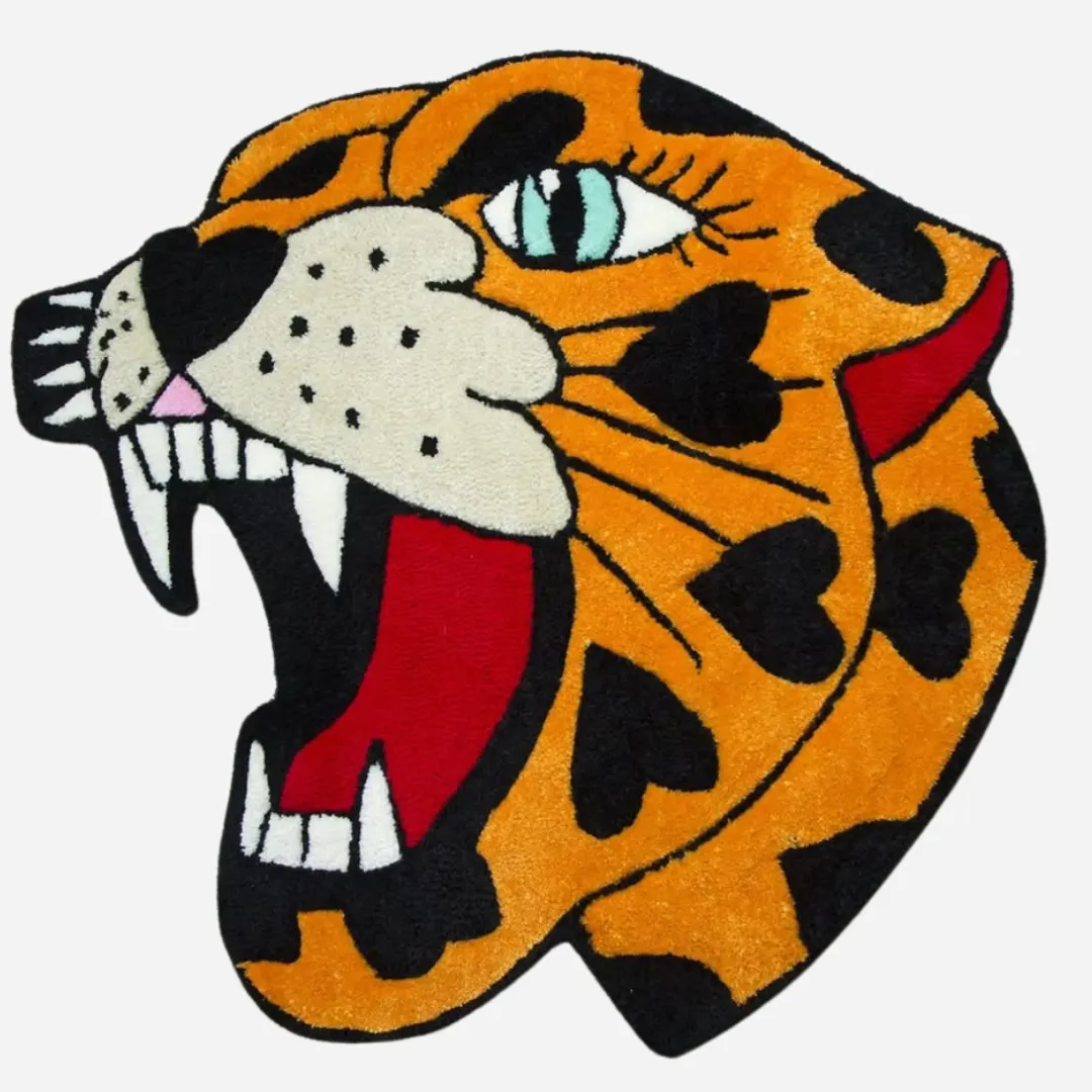 Hand-tufted Wild Panther Heart rug displayed in a modern studio with bold orange, red, and black colors.