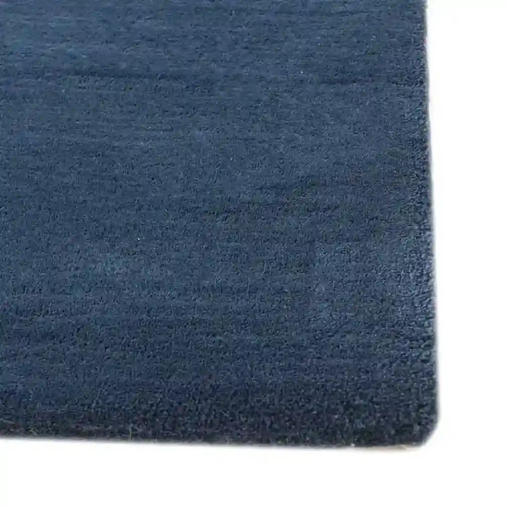 Blue wool rug for bedroom, offering durability and modern style.