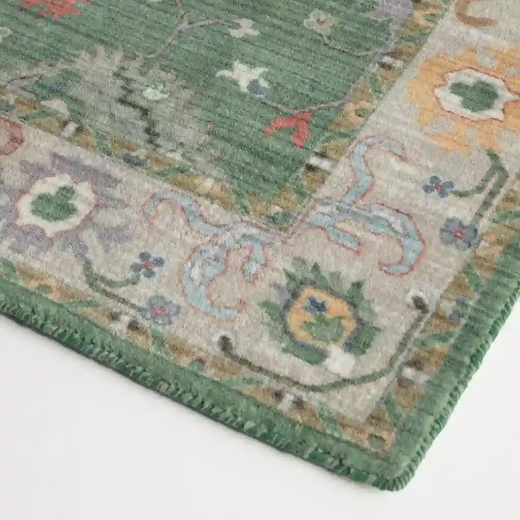 Close-up of floral design on Vintage Floral Green Hand-Tufted Rug