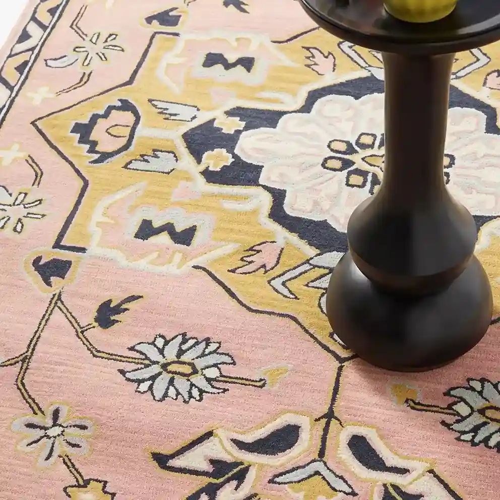 Close-up of floral wool texture on pink rug