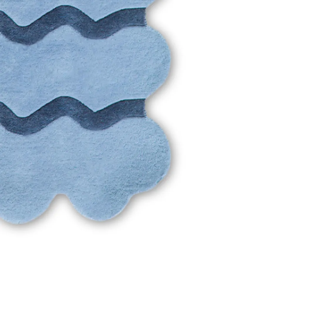 Wavy solid blue hand-tufted kitchen runner rugs made of wool, styled in a modern galley kitchen.
