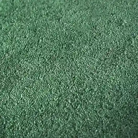 minimalist green rug styled with wood furniture