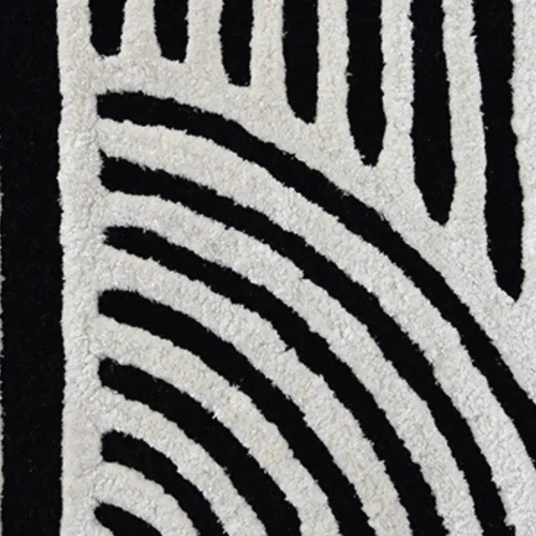 Close-up of black and white spiral line rug texture