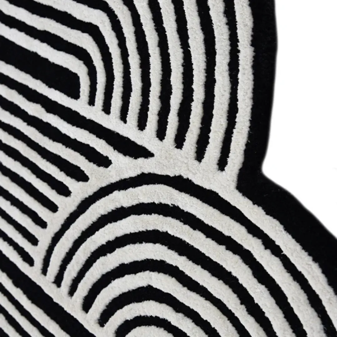 Black and white spiral area rug styled in a modern living room