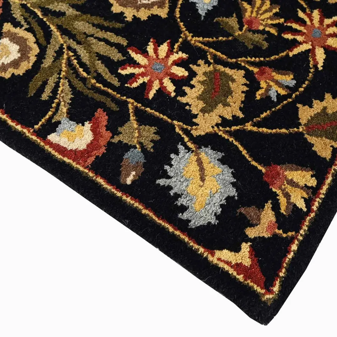 Traditional floral design rug with black base and colorful flowers