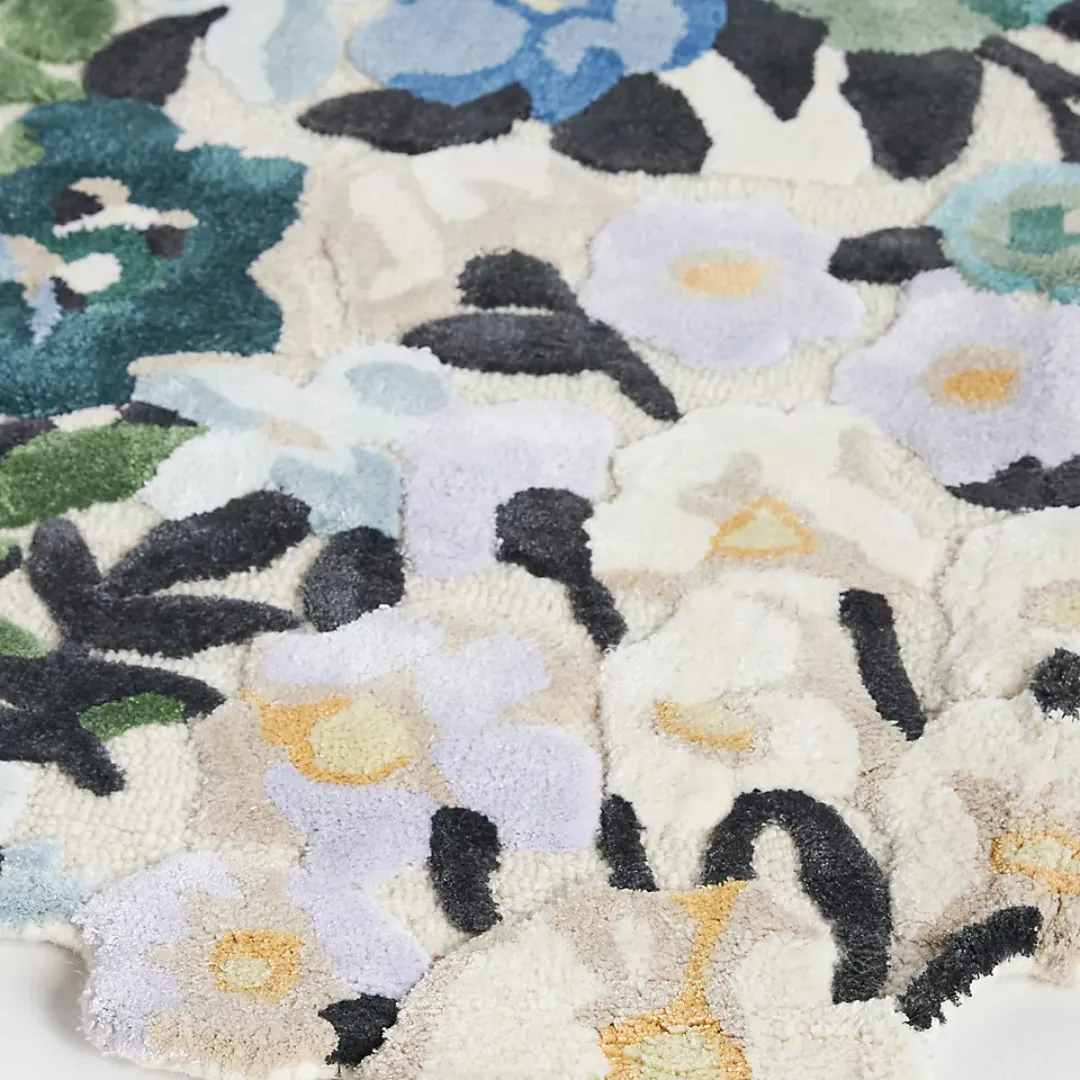 Whimsical floral rug in bright bedroom with painterly botanical print