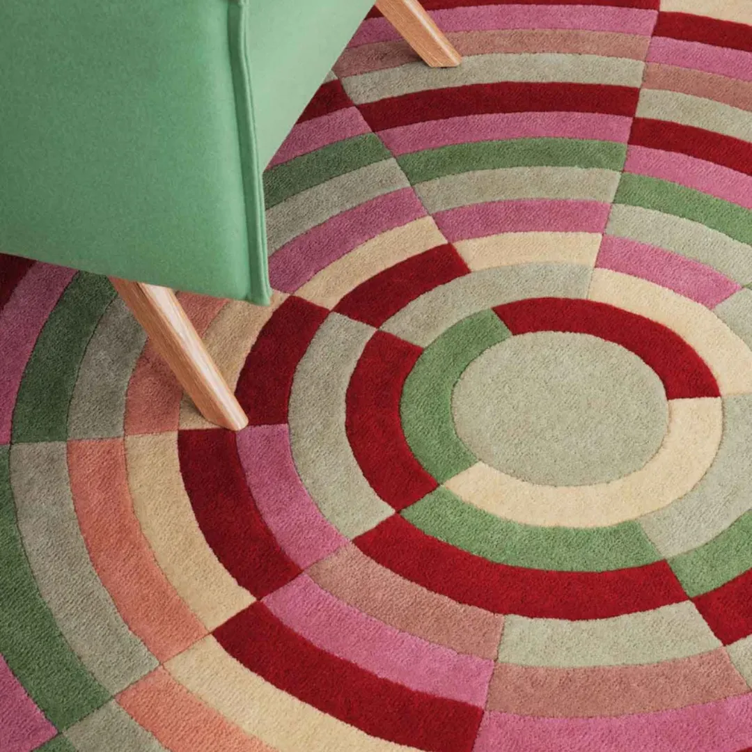 Bold boho-style round rug with rainbow spectrum pattern