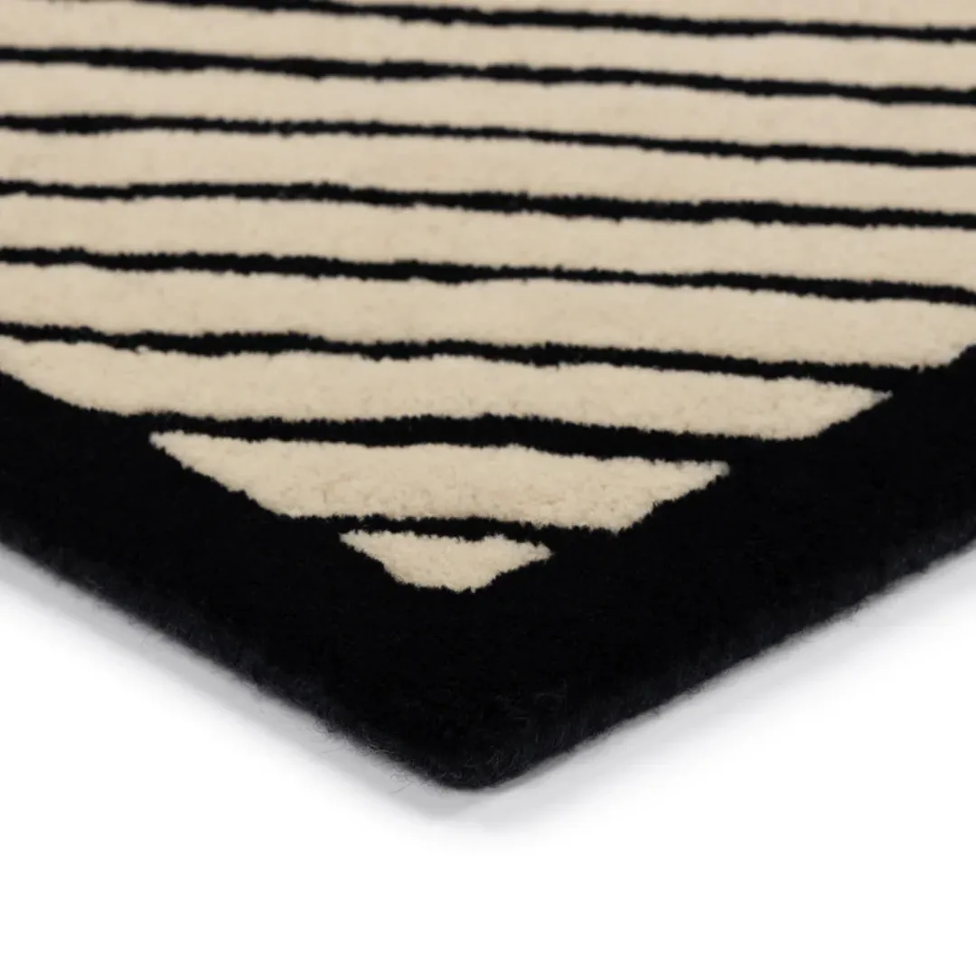 Asymmetric graphic rug featuring vertical, horizontal, and diagonal lines