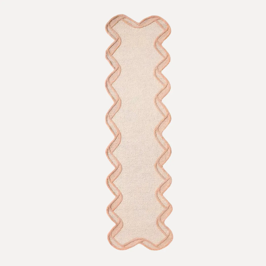 Living room styled with bright orange scallop area rug