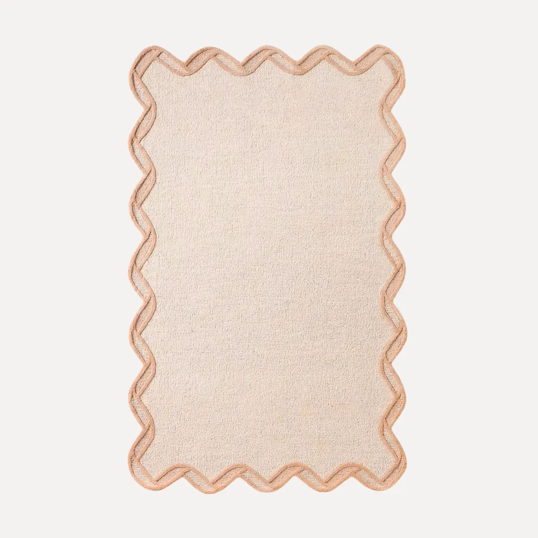 Orange scallop edge rug with warm border and curved details