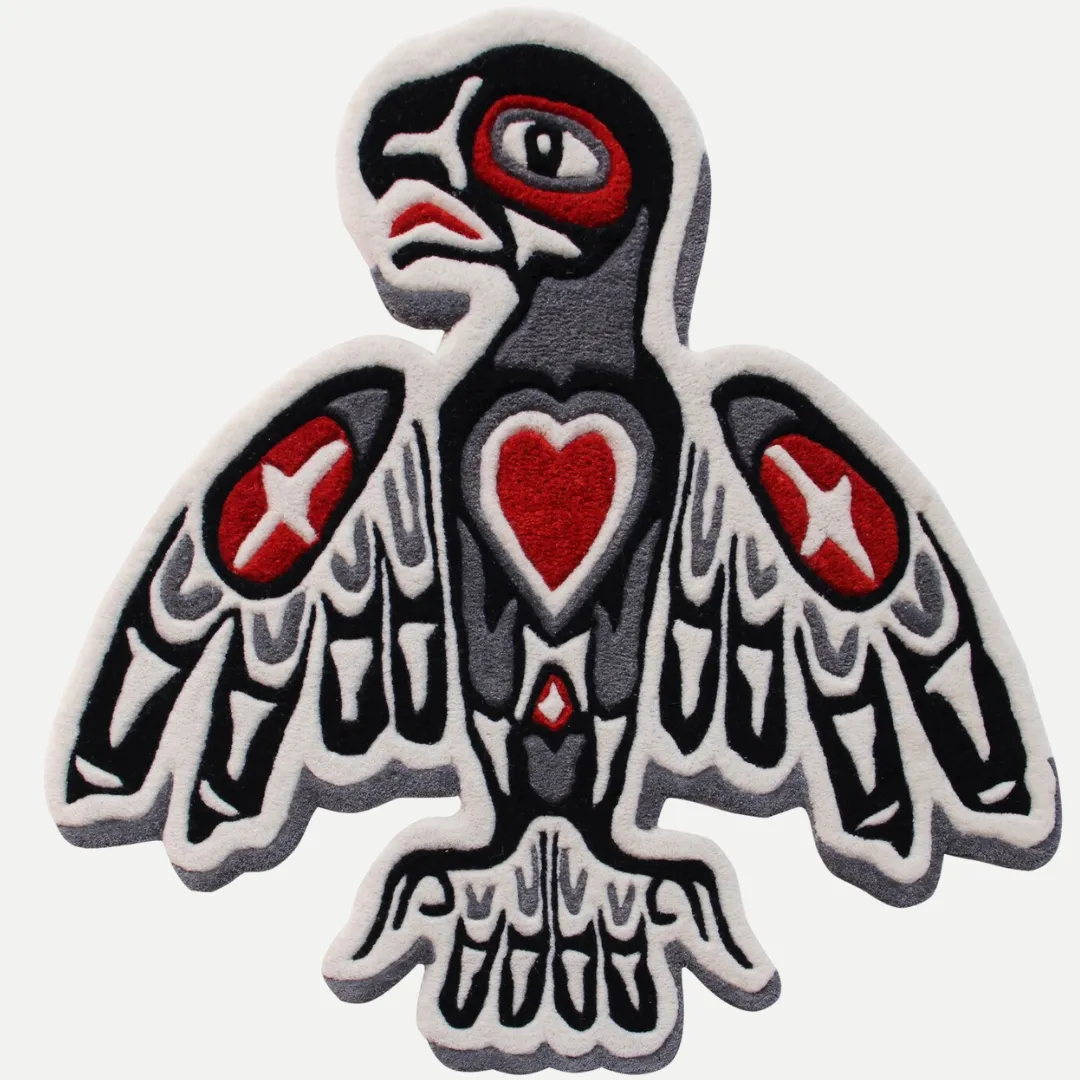 Hand-tufted tribal bird rug with red heart, star shapes, and bold black and grey outlines inspired by tattoo and cultural art