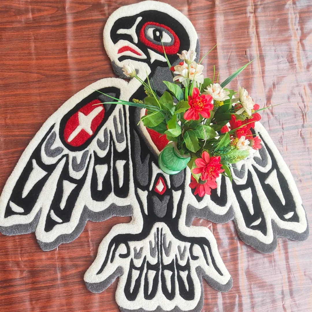 Hand-tufted tribal bird rug with red heart, star shapes, and bold black and grey outlines inspired by tattoo art