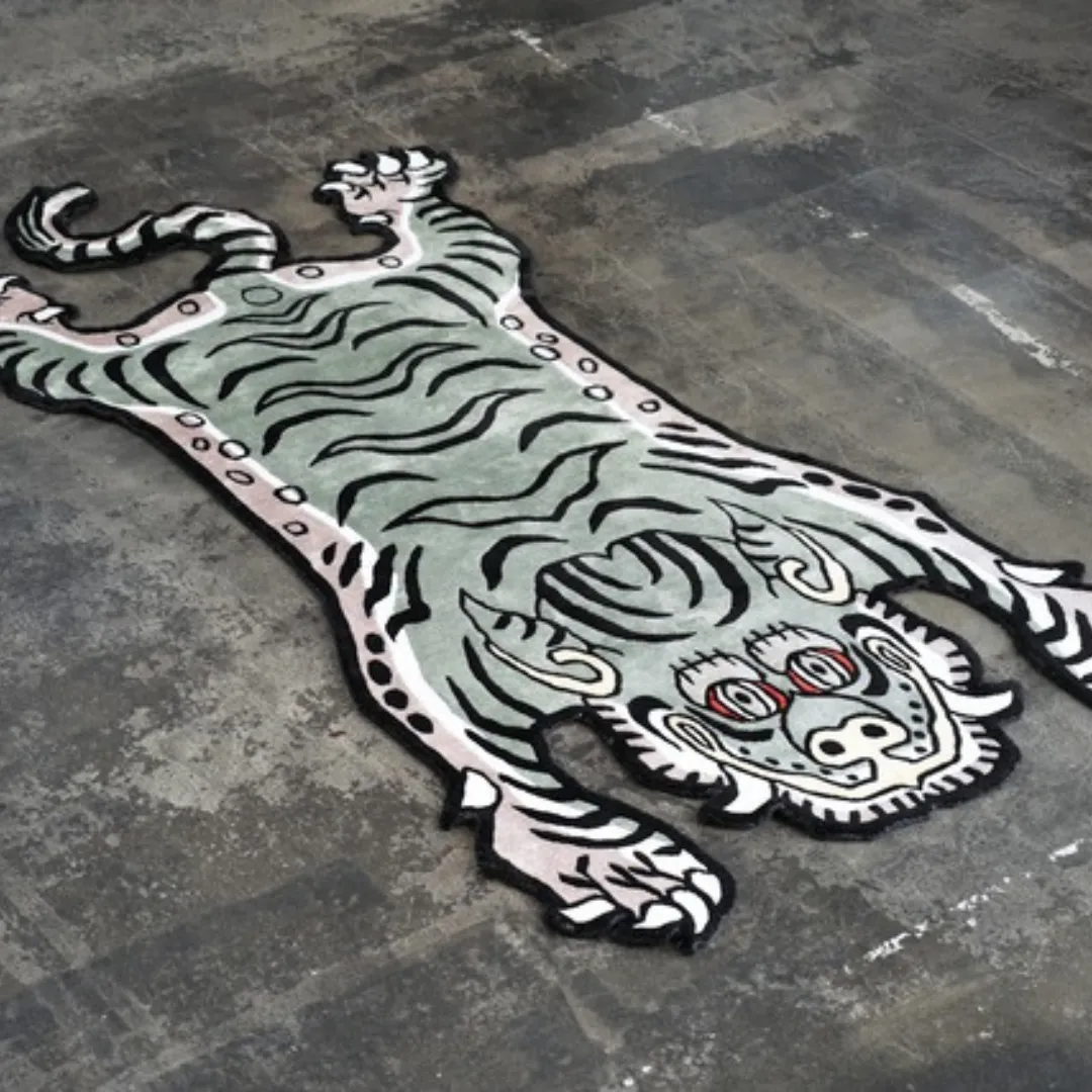 Vintage green Tibetan tiger rug on concrete floor