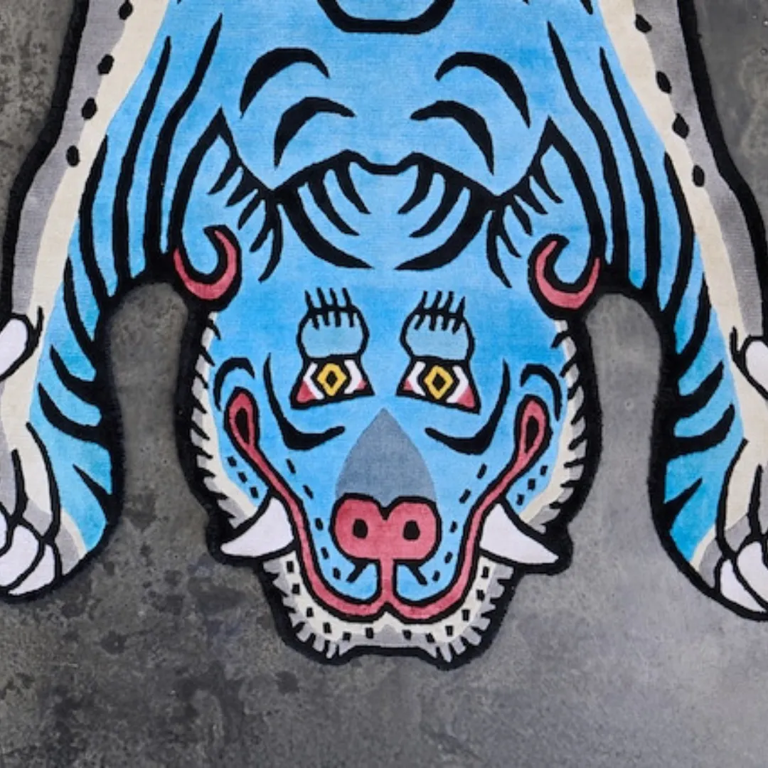 Close-up of the playful blue tiger face design on the Blue Thunder Wool Rug