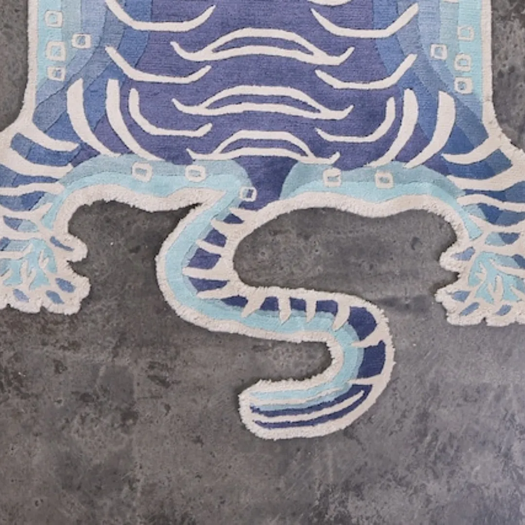 Close-up of the hand-tufted Tibetan tiger rug with blue accents