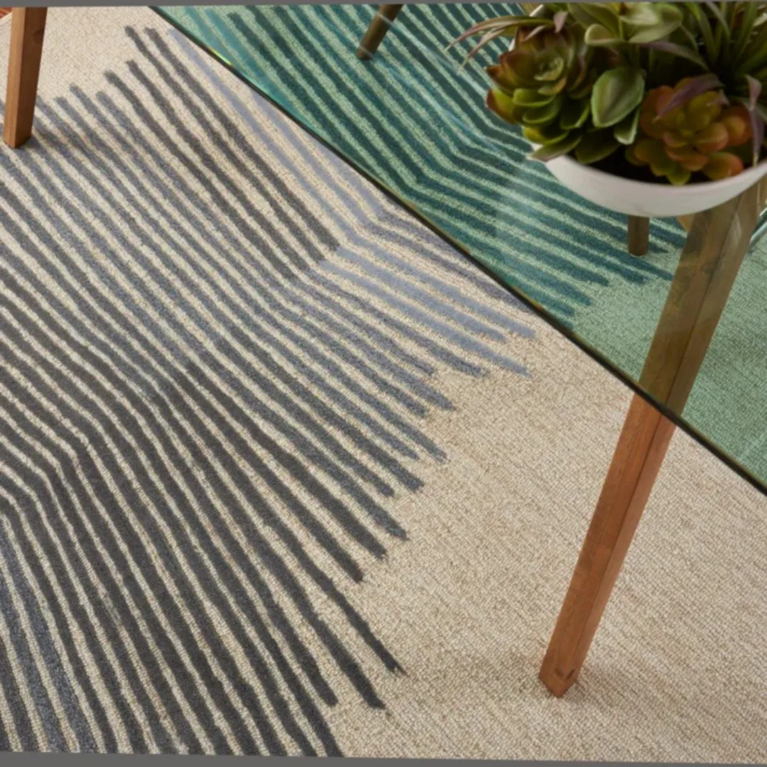 Geometric abstract rug with converging lines and subtle color gradients.