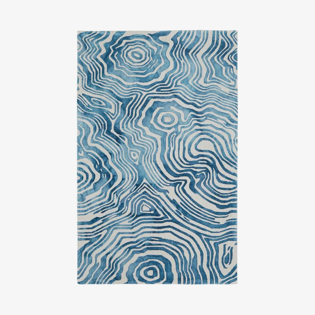 Abstract wavy pattern rug in soothing blue tones.