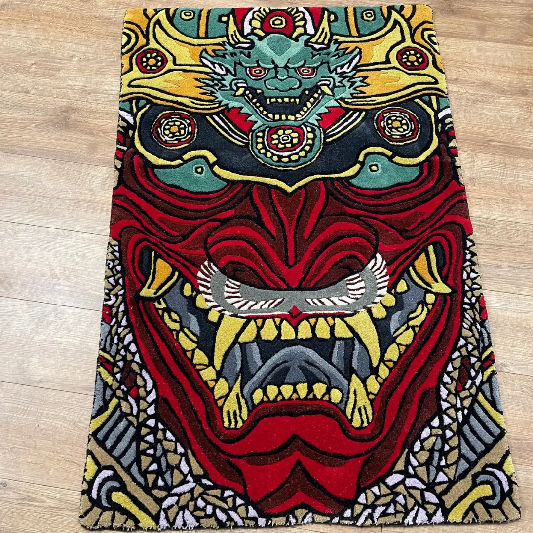 Drakona Inferno Rug Drakona Inferno Rug featuring fierce red and gold dragon mask design with intricate detailing – handmade tufted rug by Sneagear