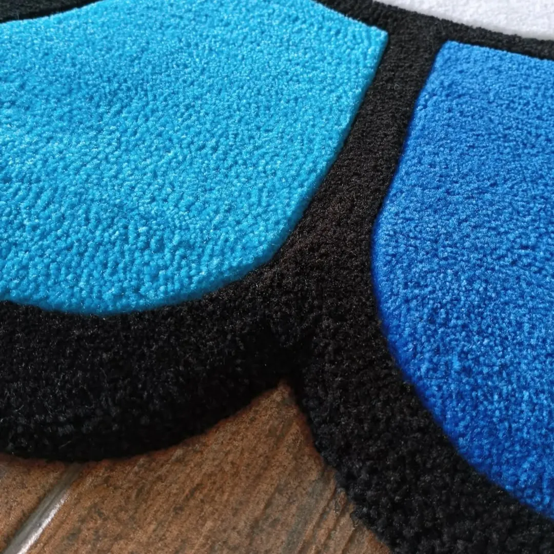 Mirage Rug Blueberry Mirage Rug – Bold blue floral-shaped rug with a cheerful smiley design, ideal for modern and creative home spaces.