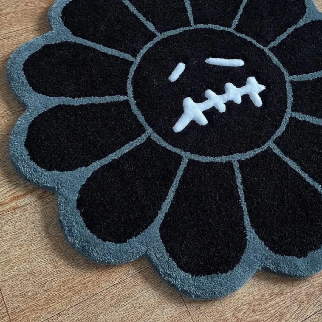 Noir Takashi Rug Handmade Noir Bloom Rug in black and grey tones, designed in a flower shape with a bold stitched expression for statement interiors.