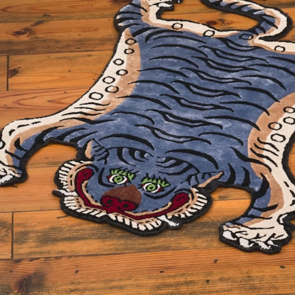 ashen claw hand tufted wool tiger rug design Angled view of the Ashen Claw rug, highlighting the dense hand-tufted wool texture and the intricate black stripe pattern on a unique blue-grey background.