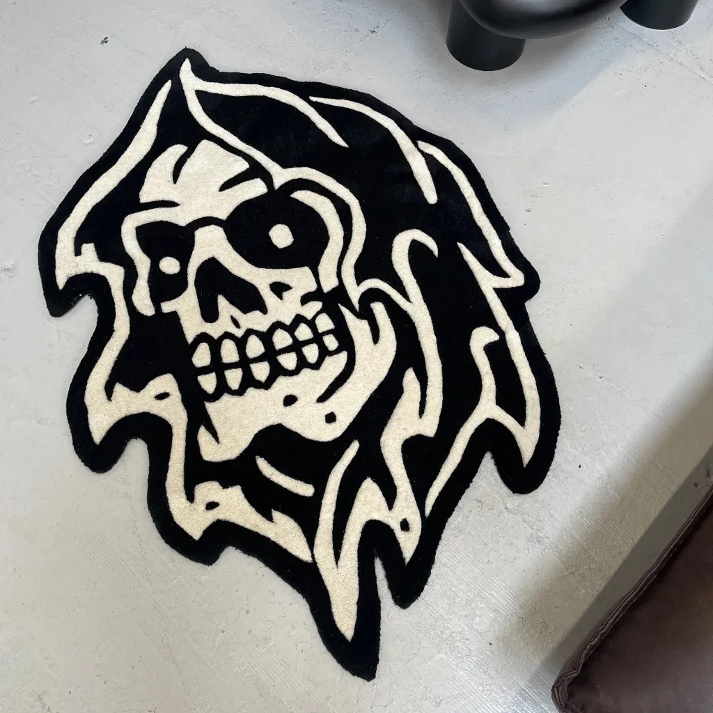 Black And White Gothic Skull Rug Top down view of the Grim Reaper rug featuring a classic American tattoo style skull design with a hooded cowl in bold black and white.