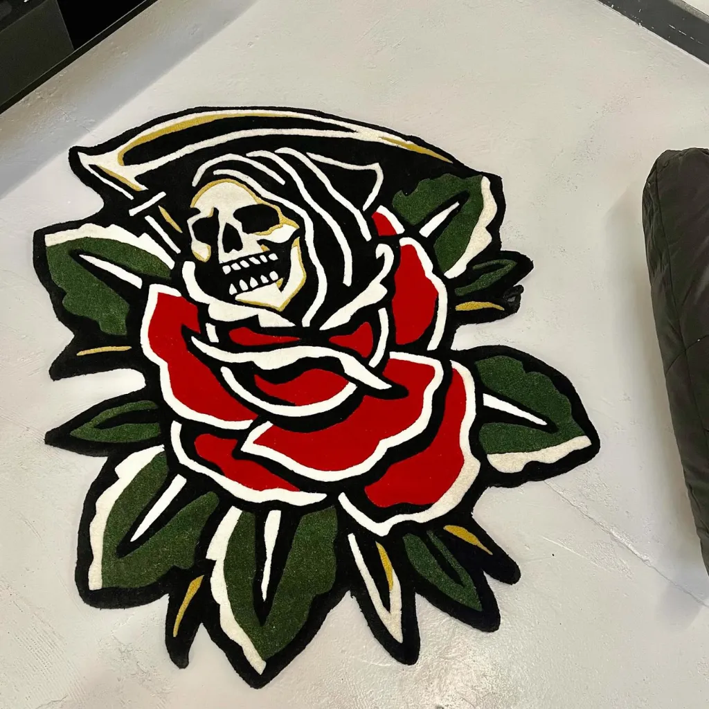 Blooming Reaper Traditional Tattoo Rug Top down view of the Blooming Reaper rug featuring a classic old school tattoo design with a grim reaper skull holding a scythe emerging from a vibrant red rose.