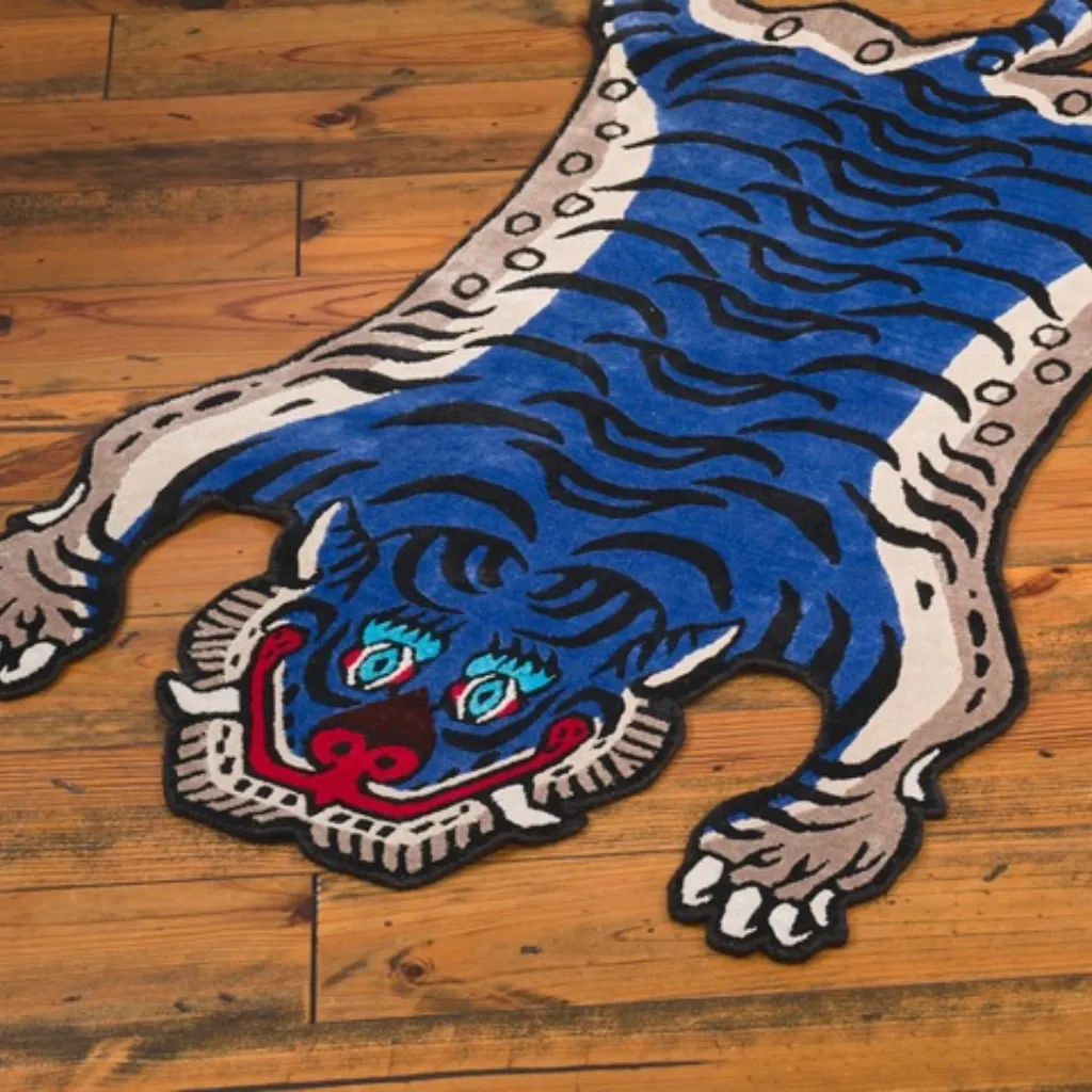 cobalt fang hand tufted blue tibetan tiger rug design Angled view of the front section of the Cobalt Fang rug, highlighting the dense hand-tufted wool texture and the intricate blue and black stripe pattern inspired by Tibetan folk art.