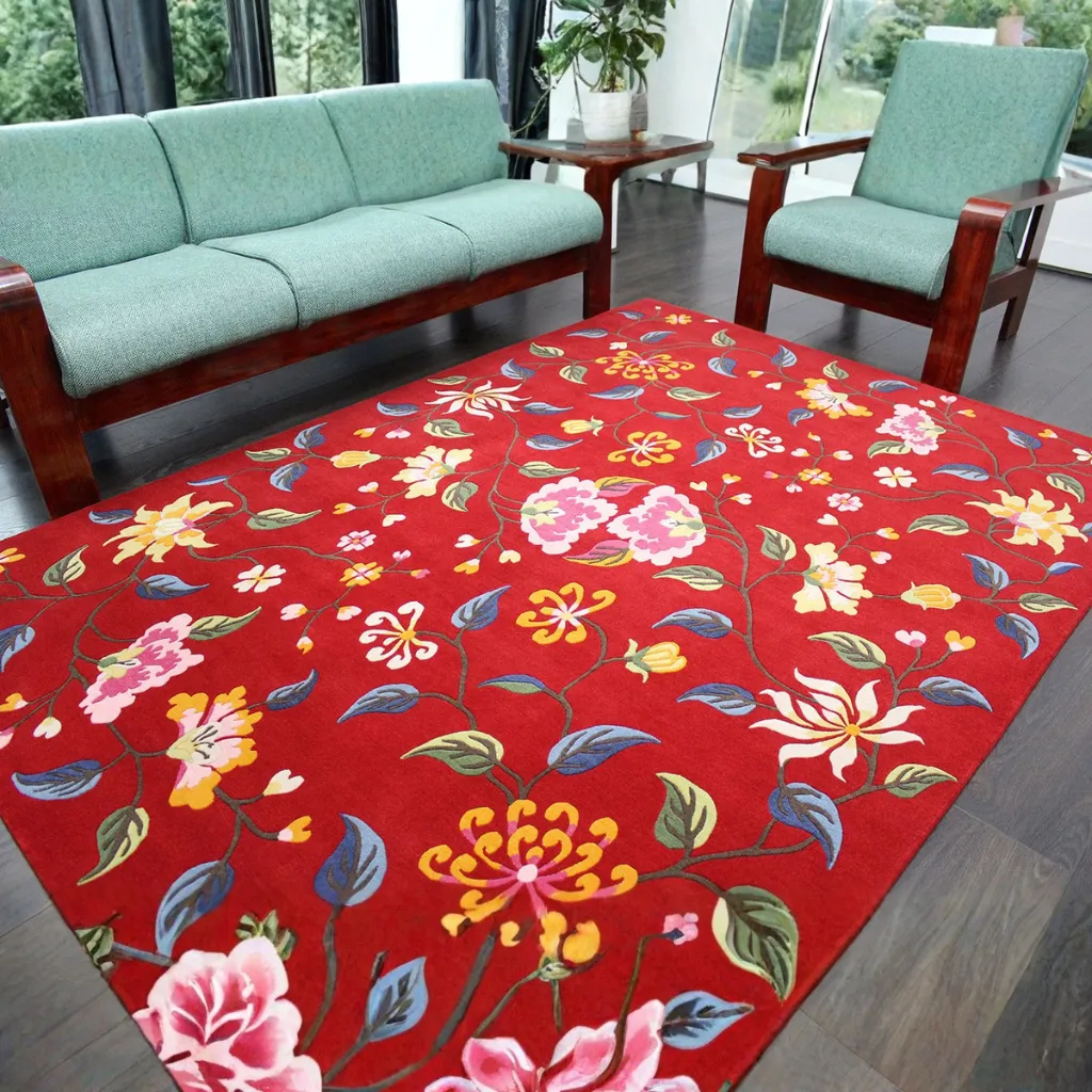 crimson valley red floral area rug living room The Crimson Valley rug styled in a living room with green furniture, adding a bold botanical touch to the space with its deep red base and colorful flower design.