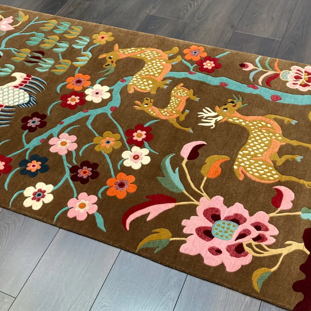 earthen story rug wool texture detail Close up detail shot of the Earthen Story rug highlighting the intricate hand tufted wool texture and the vibrant spotted deer and floral motifs.