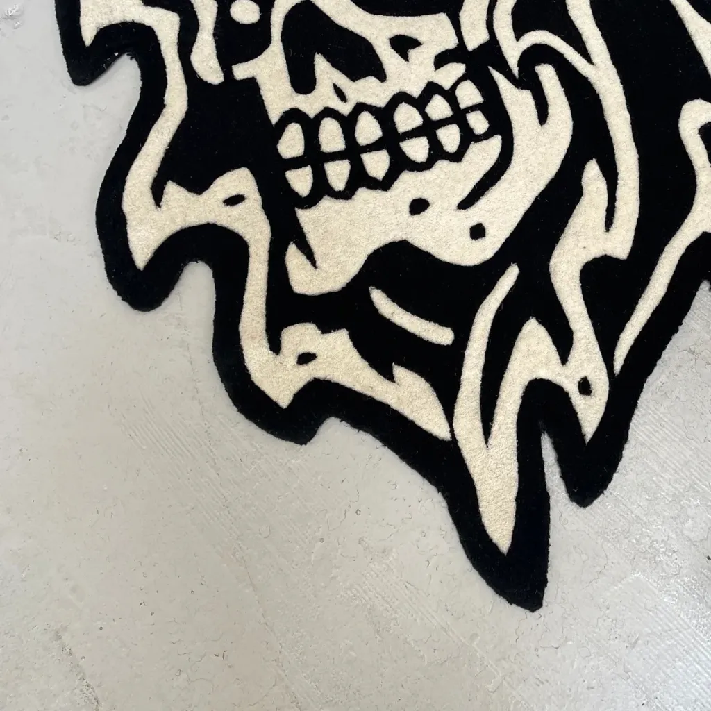 Grim Reaper Rug Wool Texture Detail Extreme close up detail of the Grim Reaper rug highlighting the dense hand tufted wool texture and the sharp definition of the skeletal teeth and jawline.