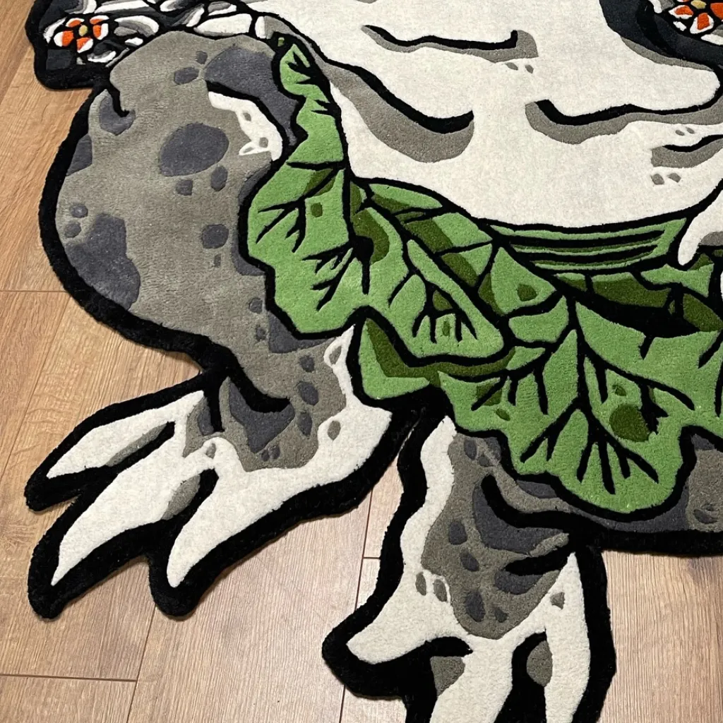 kaeru no bujin rug texture detail leaf skirt Extreme close-up of the Kaeru No Bujin rug, highlighting the dense hand-tufted wool pile, carved 3D texture of the green leaf skirt, and the grey speckled skin detailing.