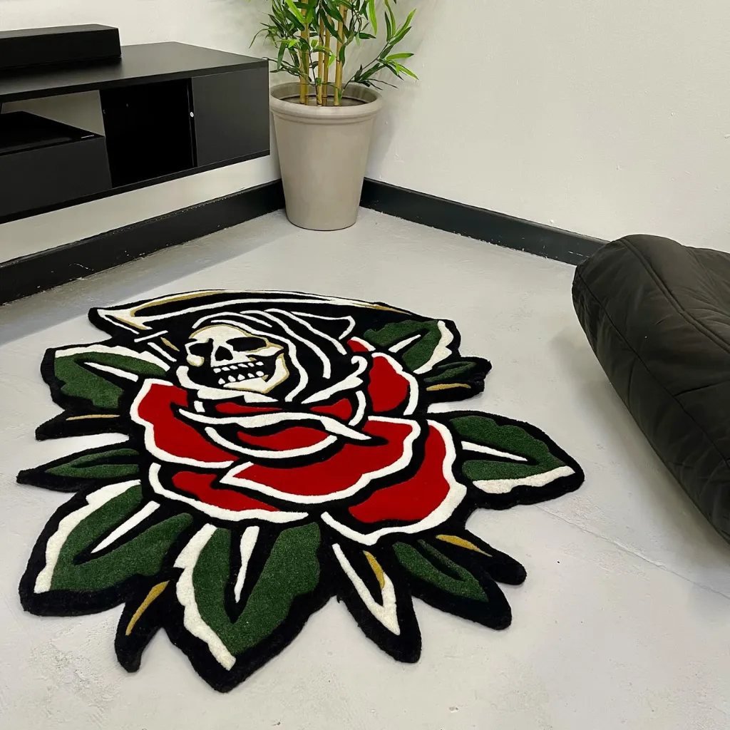 Skull And Flower Flash Art Area Rug Low angle perspective of the Blooming Reaper rug showing the dense hand tufted wool texture and the rich contrast between the white skull and deep red flower petals.