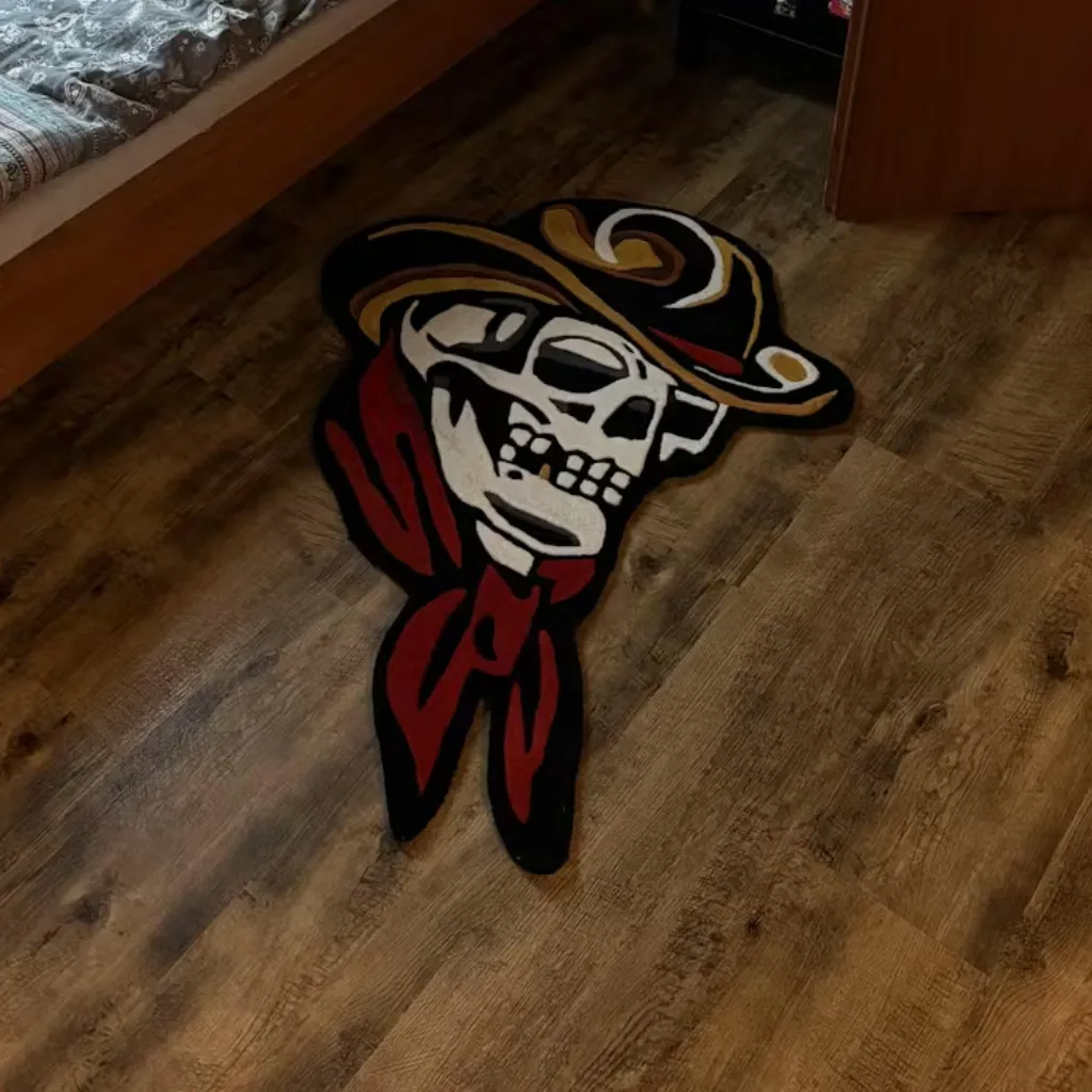 Western Style Skull And Bandana Floor Rug High angle shot of the Skull Cowboy rug placed near a bed, highlighting the bold black outlines and the western aesthetic of the hand tufted design.