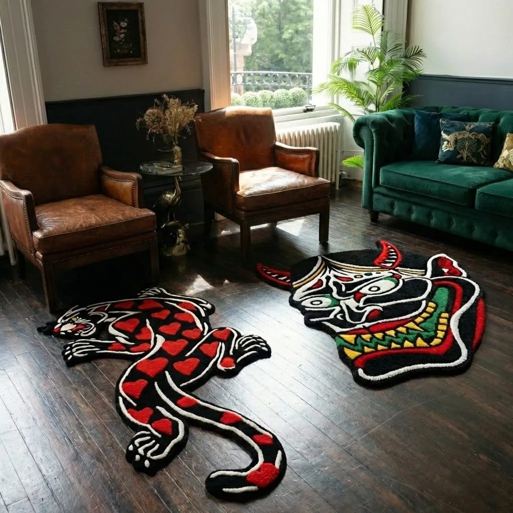 amour panther inked red panther rug head detail High angle view of the full Amour Panther rug placed on a rustic wooden floor, showcasing the classic panther skin shape reimagined with a soft pink background and heavy black tattoo-style contours.