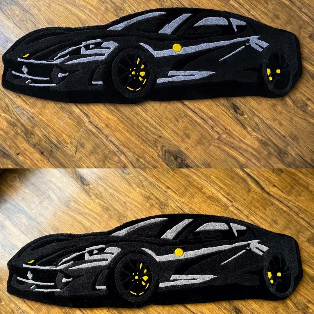shadow monarch supercar side profile rug Full top-down view of the Shadow Monarch rug illustrating the side profile of a black sports car with detailed grey highlights and yellow rims.