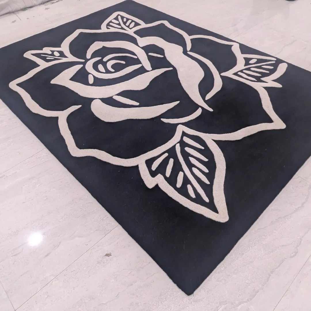 shadow rose black white floral rug Full view of the Shadow Rose rug featuring a bold, oversized white rose outline design on a deep black hand-tufted wool background.