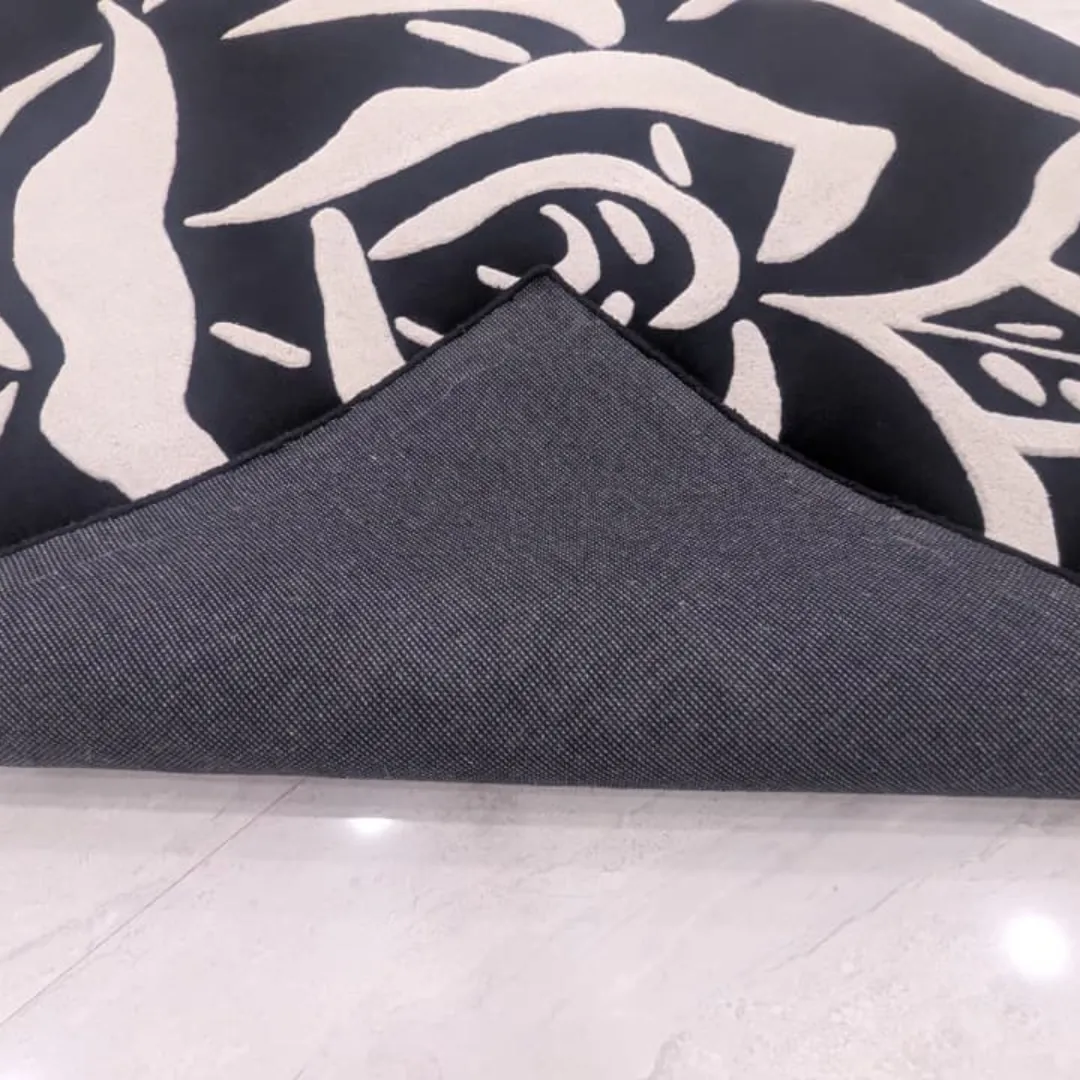 shadow rose rug canvas backing detail Close-up view of the underside of the Shadow Rose rug, revealing the durable grey canvas backing and high-quality edge binding construction.