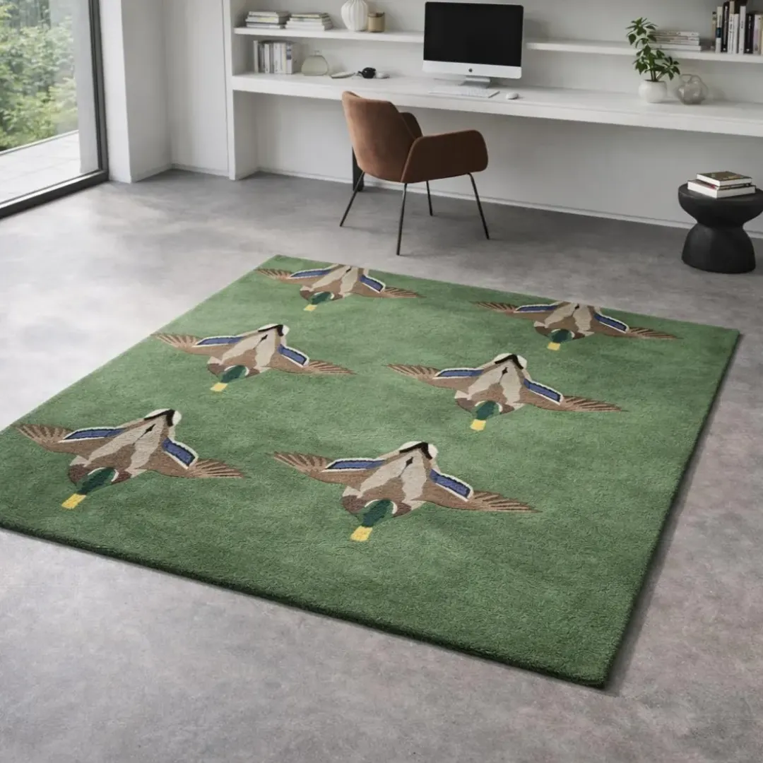 verdant flight rug office study decor Angled view of the Verdant Flight rug featuring a repeating pattern of detailed flying mallard ducks on a lush green hand-tufted wool background.